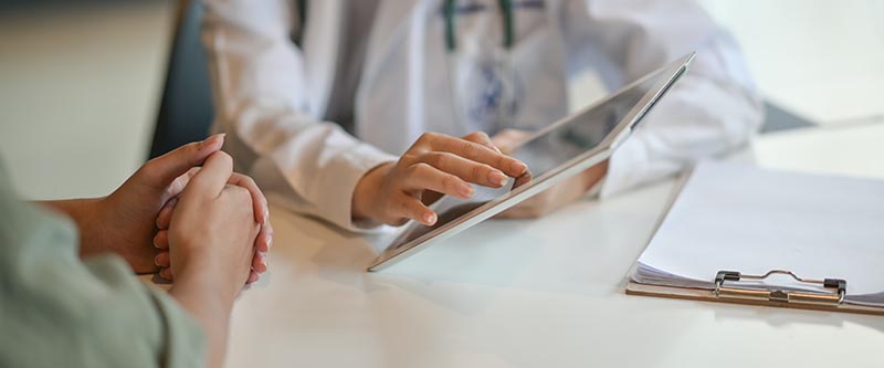 A doctor uses an ipad