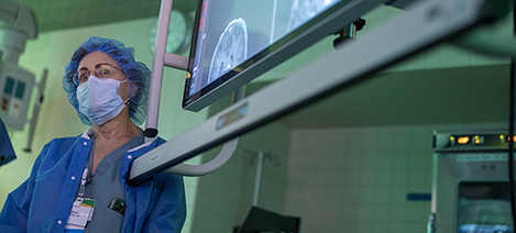 A woman stands watch in neurosurgery